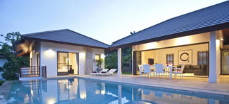 Koh Samui villa exterior dining area around swimming pool, at evening.