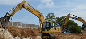 Excavator moving dirt on a construction site.