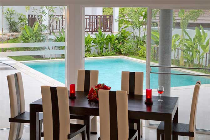 Villa dining room with pool view.