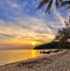 beachfront land with sunset