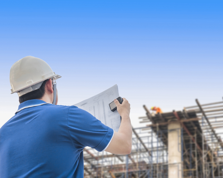 Engineer is inspecting his work in building construction site