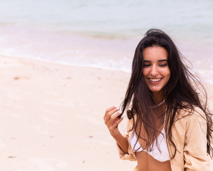 romantic-portrait-woman-beach-windy-day-sunset-warm-light